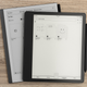 The Amazon Kindle Scribe sitting on the reMarkable 2 sitting on a wooden desk.